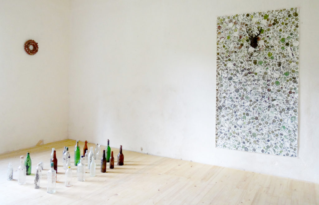 CLAIRE EBENDINGER, THE PHOENIX OF THE HOSTS OF THIS WOOD, GLASS BOTTLES FOUND IN THE FOREST, ACRYLIC PRINT ON PAPER, TOWEL HOLDER AND DECORATIVE CROWN, VARIABLE DIMENSIONS, 
(PRINT 1 X 1,70 M)